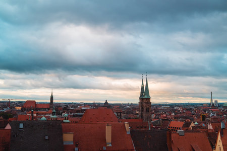 Cloudy City Landscape of Nuremberg Germany on a Morning Looking Over the City Line Into the Horizon of a Beautiful View Watching Onto a Church and the Traditional Rooftops of the Housesの写真素材