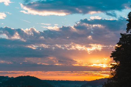 Colorful Sunrise Shining Through the Clouds in the Sky Early in the Morningの写真素材