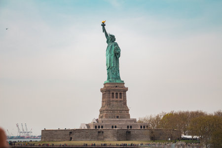 Statue of Liberty on Liberty Island From the Side in a Wide Shot with the Sky in the Backgroundの写真素材