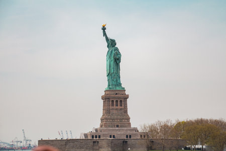 Statue of Liberty on Liberty Island From the Side in a Wide Shot with the Sky in the Backgroundの写真素材