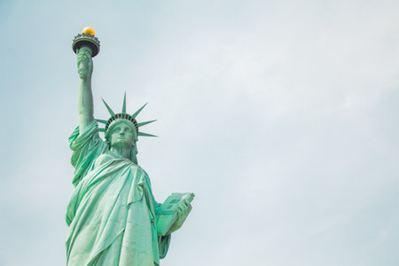 Statue of Liberty viewed from the front in a medium full shot with sky in the backgroundの写真素材