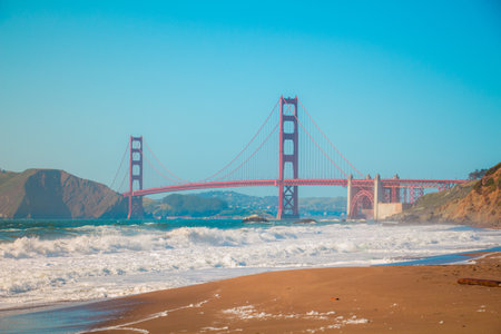 Golden Gate Bridge View From Baker Beach With Waves of the Ocean Waving to the Shoreの写真素材