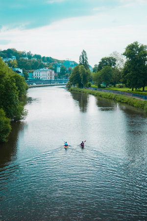 Two Kayak Boats Paddling on a Riverの写真素材