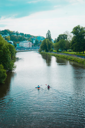 Kayak Boats Paddling on a River Canalの写真素材