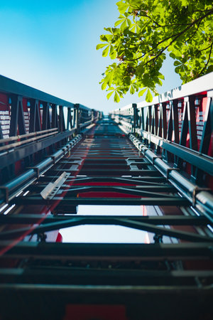 Rescue Fire Escape Ladder on a Fire Truck Rising High Into the Skyの写真素材