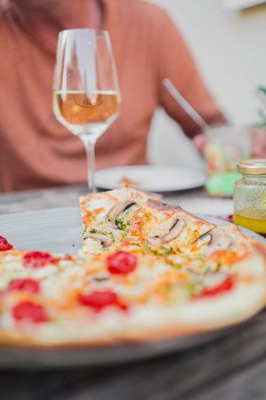 Traditional French Tarte Flambee Flammkuchen from Alsace with Creme Fraiche Bacon Onions and Vegetables Fresh From the Oven on a Beautiful Summer Dayの写真素材