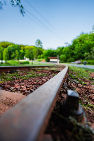 Metal Train Railway Track Close-up on the Floor in a Park Environment on a Hot Sunny Summer Dayの写真素材