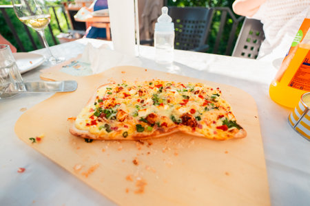 French Tarte Flambe Flammekueche with CrÃ©me Fraiche Cheese Spring Onions on a Wooden Tableの写真素材