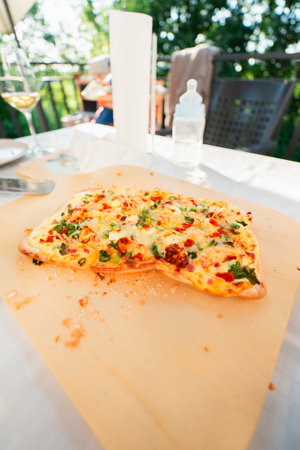 French Tarte Flambe Flammekueche Crust with CrÃ©me Fraiche Cheese Spring Onions on a Wooden Tableの写真素材