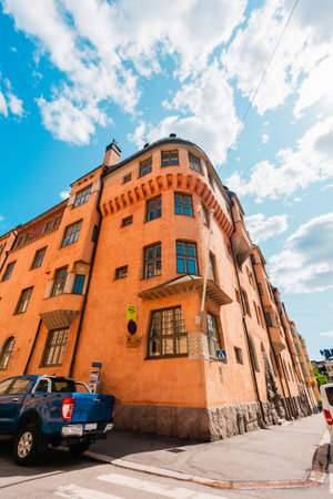 Corner of an Orange Multi Level Apartment Building on a Hot Summer Dayの写真素材