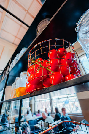 Basket of Red Jucy Tomatoes on a Black Shelfの写真素材