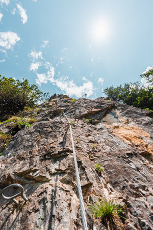 Via Ferrata Along a Steep Face Stone Cliff Wallの写真素材