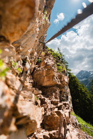 Via Ferrata Steel Wire Cable Leading Up a Climbing Pathon a Stony Mountain Cliffの写真素材