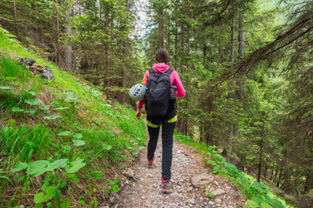 Sport Hiker Stepping Down a Stony Hiking Path in the Forest