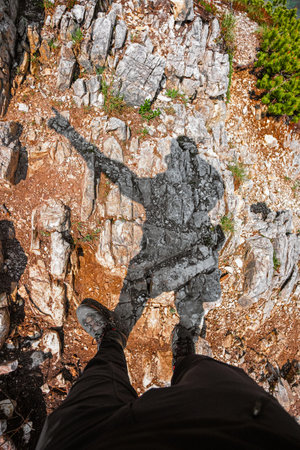 POV View of a Hikers Shadow Pointing into the Leading Directionの写真素材