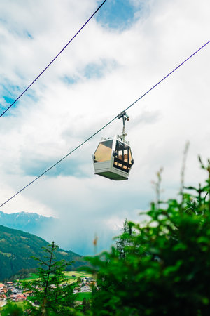 Cable Car Cabin Viewed From the Bottom Ascending Up the Mountainの写真素材