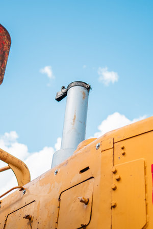 Exhaustion Pipe of an Excavator Reaching Up into the Skyの写真素材