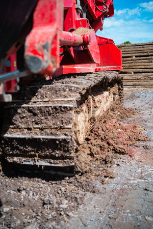 Dirty Continuous Track of a Construction Vehicle on a Civil Engineering Construction Siteの写真素材