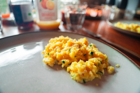 Healty Yellow Scrambled Egg With Leek for Breakfast Mealtime on a Plate Close-up