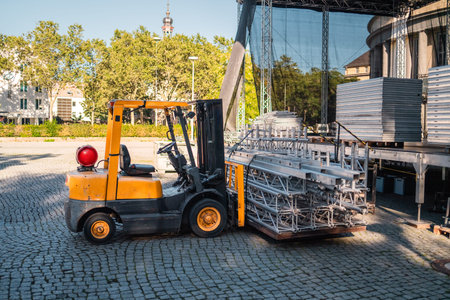 Yellow Heavy Load Lift Truck Transporting Stage Equipment to the Event