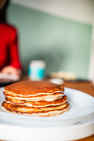 Pile of Soft Fluffy Delicious Pancakes Stacked Onto Each Other on a White Plate