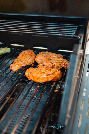 Grilled Steak Meat on a Flaming Black Grill Close Up in Summer Season