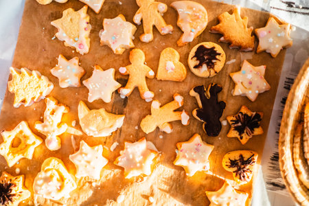 Freshly Baked Form Biscuits with Sugar Coat and Springles on Baking Paper for Christmas Top Down...