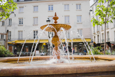 Fountain of Water Shooting into the Air on a Plaza in the City on a Sunny Summer Dayの写真素材
