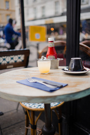 Glass of lemon juice on a wooden round table in a restaurantの写真素材