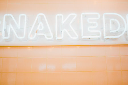 White Hazy Neon Light with the Label Over a Tile Beige Wallの写真素材