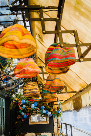 Colorful Basket Lamp Shade Made of Natural Straw Hanging from the Ceiling of a well decorated CafÃ©の写真素材