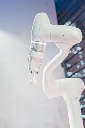 Minimalistic White Robot Arm with Claw Ready to Grip Objectsの写真素材