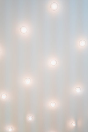 Bright Row of Spotlights on a White Ceiling Highlighting the Room Indoorsの写真素材
