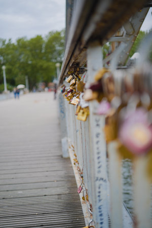 Metal Love Padlocks Hanging on the Railing of the Bridgeの写真素材