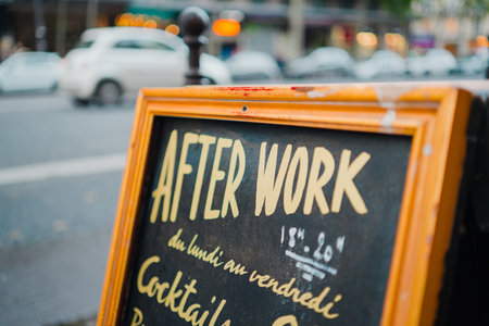 Orange and Yellow Sign on the Street Showing Advertising for After Work Event in a Bar in Paris Franceの写真素材