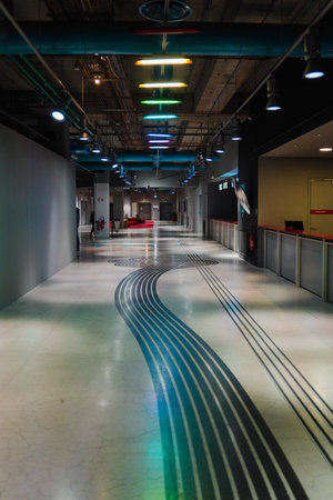 Underground Hallwayy of a Public Place with Artistic Painting on the Floor and Colorful Light on the Ceilingの写真素材