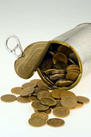 coins poured from  tin  bankの写真素材