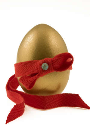 Golden testicle  decorated with red ribbonの写真素材