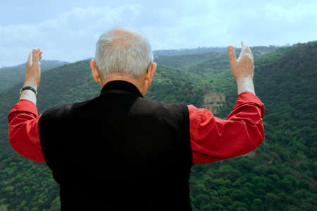  	 The man thanked God lifting hands to heavenの写真素材