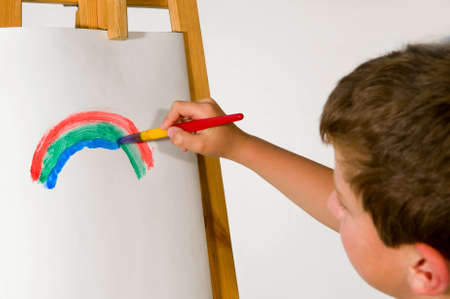 Boy drawing on paper a large brush, rainbow の写真素材