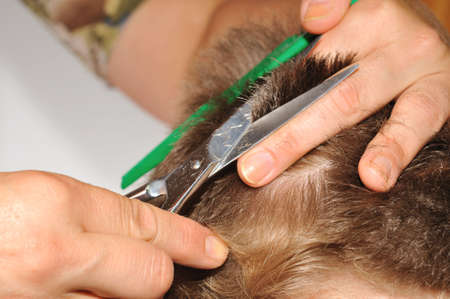 Hairdresser shows how to cut scissors and combの写真素材