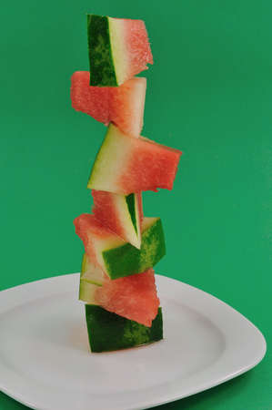 	watermelon cut into pieces and folded in the form of the towerの写真素材