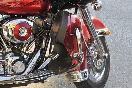Fragment of the parked motorcycle, red colorの写真素材