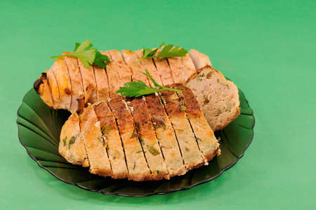 Meat loaf two species with green leaves lying on a plateの写真素材