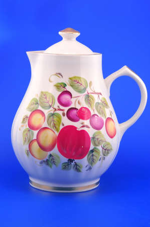 Painted white pitcher photographed in front of blue background の写真素材