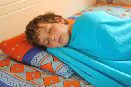 The boy sleeps in the morning before schoolの写真素材