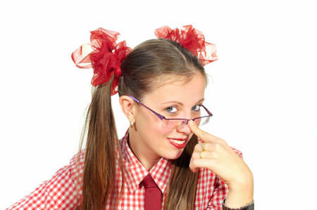 The girl with red ribbons smiling adjusting his glasses の写真素材
