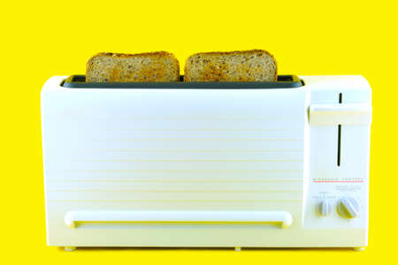 Two slices of white bread flour coarse baked in a toasteの写真素材