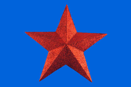  Red five-pointed star toy Christmas tree against a white background の写真素材