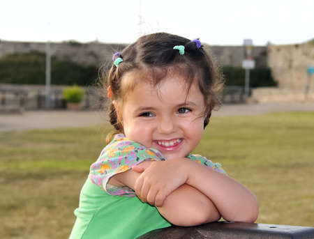 Cute little girl smiling, posing for the photographerの写真素材